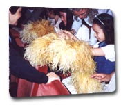 Children examining stage props at an audio-described performance of a play